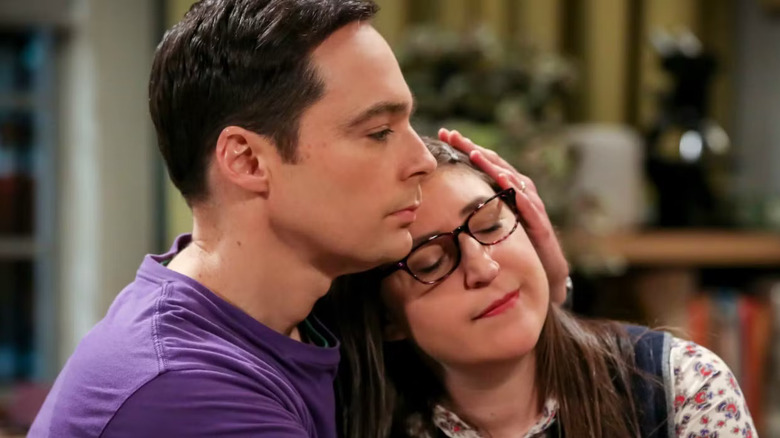 Sheldon holding Amy on the couch on The Big Bang Theory