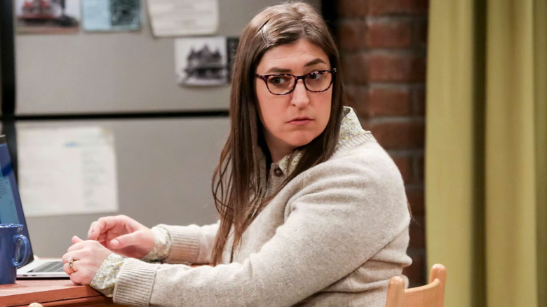 Amy looking over her shoulder while typing on her computer on The Big Bang Theory