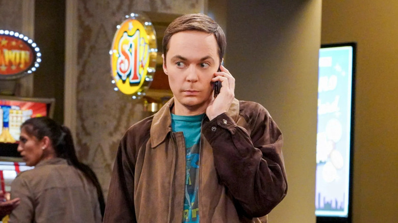 Sheldon Cooper holding a phone to his ear on The Big Bang Theory