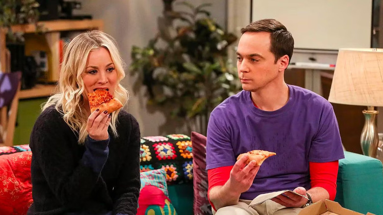 Penny eating pizza and Sheldon watching on The Big Bang Theory