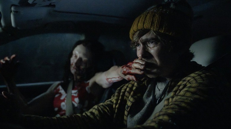 Austin Abrams as Bryan with a zombie covering his mouth in Resident Evil (2026)