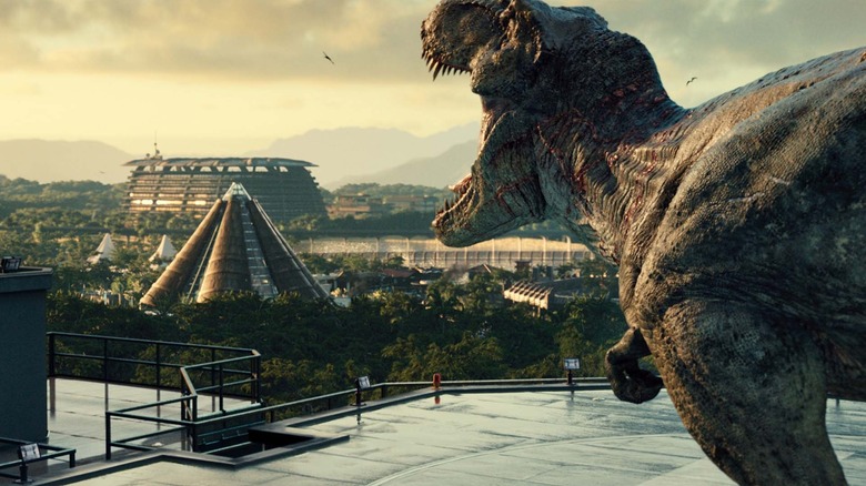 T-Rex stands in front of the remains of the park and roar in Jurassic World