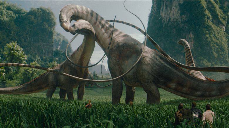 A herd of titanosaurus grazing in a huge valley in a Jurassic world rebirth