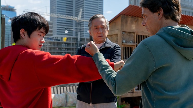 Li Fong and Daniel LaRusso practicing karate while Mr. Han watches in Karate Kid: Legends