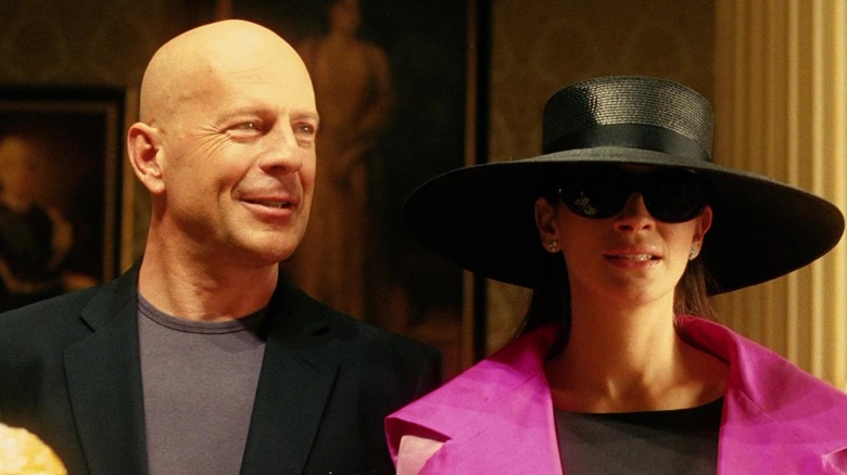 Bruce Willis himself appears standing next to Tess Ocean, played by Julia Roberts, in Ocean's Twelve.