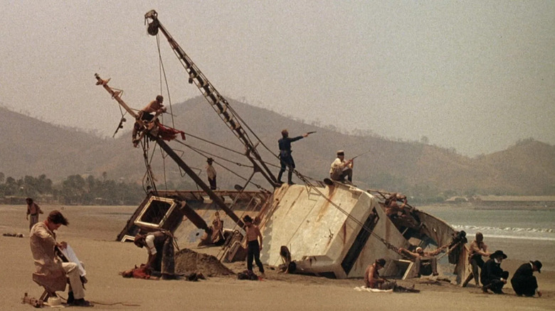 Soldiers fighting on a boat blocked on dry land, a Walker.