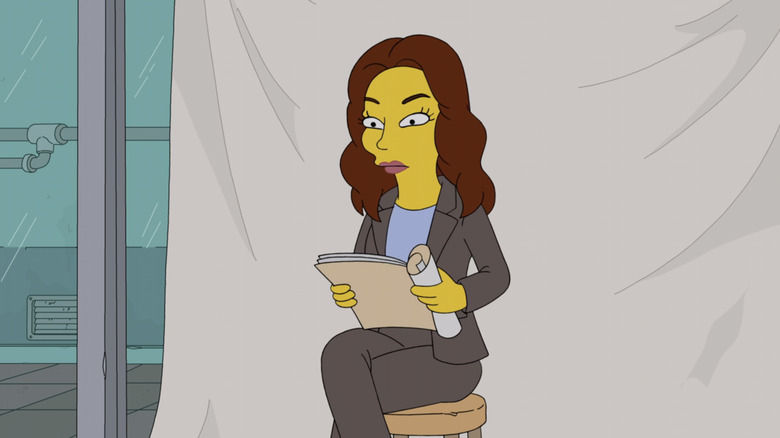Emily Deschanel sits against a white background in The Simpsons