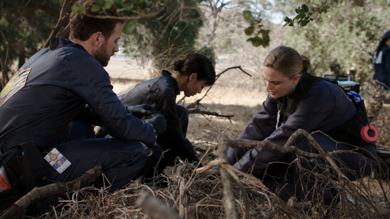 Emily Deschanel's Temperance Brennan investigates a body in the field alongside fellow forensic scientists in Bones