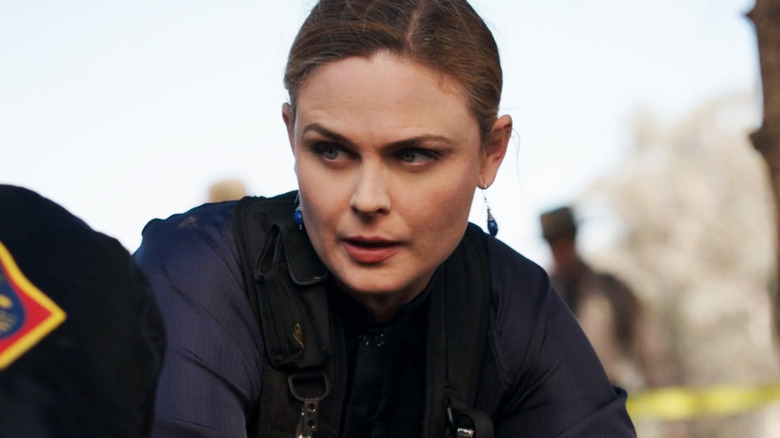 Emily Deschanel's Temperance Brennan looks off to her right during a crime scene visit in Bones