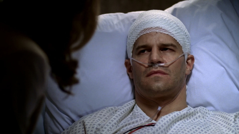 David Boreanaz's Seeley Booth looks up from a hospital bed at Emily Deschanel's Temperance Brennan in Bones