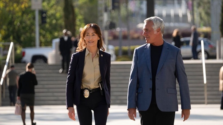 Detective Ballard and Bosch talk while walking through downtown Los Angeles in "Ballard"