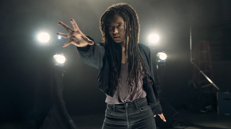 Jaz Sinclair as Marie Moreau holding out her hand dramatically with spotlights behind her in Gen V season 2