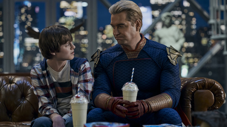 Cameron Crovetti as Ryan and Antony Starr as Homelander sitting together with shakes on The Boys