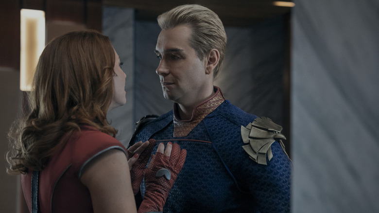 Valorie Curry as Firecracker placing her arms on the chest of Antony Starr as Homelander in his penthouse in The Boys