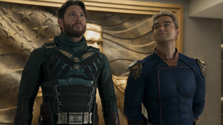 Antony Starr as Homelander standing next to Jensen Ackles as Soldier Boy in a conference room in The Boys