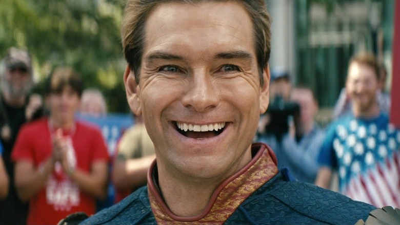 Homelander smiling after people praise him for murdering a random guy in a busy street in The Boys