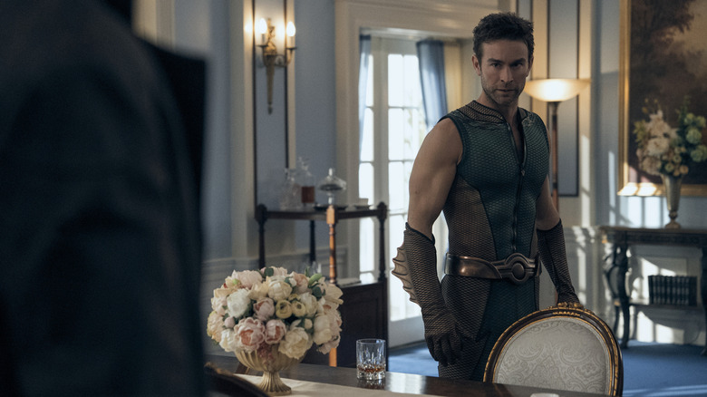 Chace Crawford as The Deep standing in a room of the White House opposite Karl Urban as Billy Butcher in The Boys