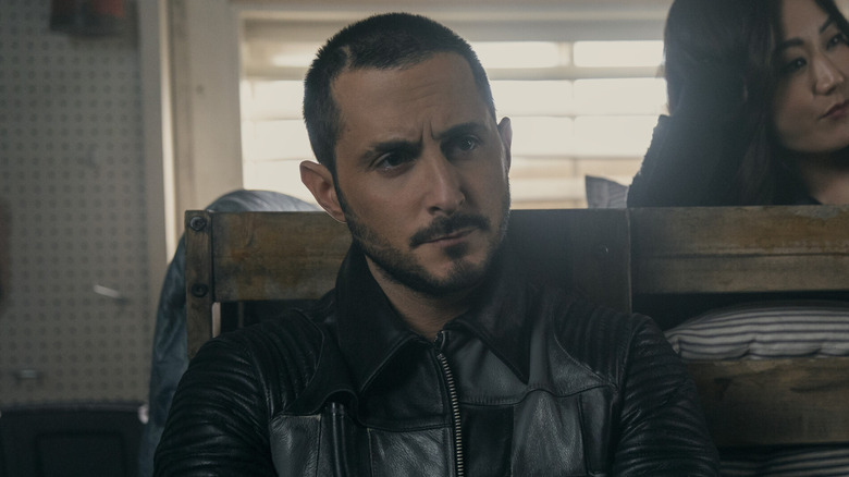Tomer Capone as Frenchie, sitting against a bed with Kimiko in The Boys.