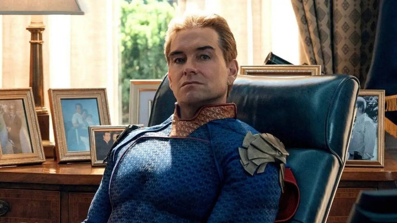 Antony Starr as Homelander sitting at the president's desk in The Boys.