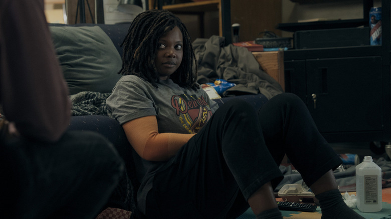 Susan Heyward as Sister Sage, sitting on the floor in The Boys.