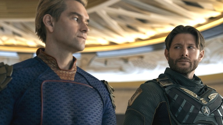 Antony Starr as Homelander wearing his superhero suit standing beside Jensen Ackles as Soldier Boy in The Boys