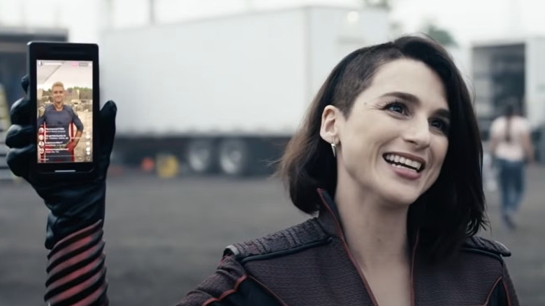 Stormfront holding cell phone with livestream of Homelander on screen in The Boys