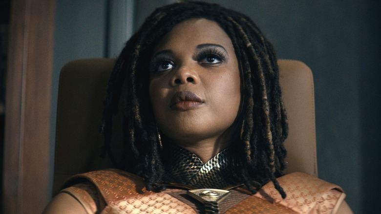 Sage speaks to someone offscreen while lounging in her chair in The Boys