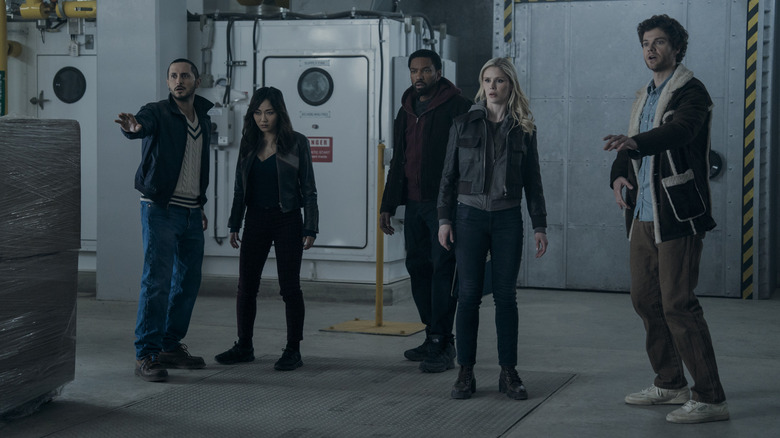 Tomer Capone as Frenchie, Karen Fukuhara as Kimiko, Laz Alonso as MM, Erin Moriarty as Annie, and Jack Quaid as Hughie standing in a warehouse and looking alarmed in The Boys