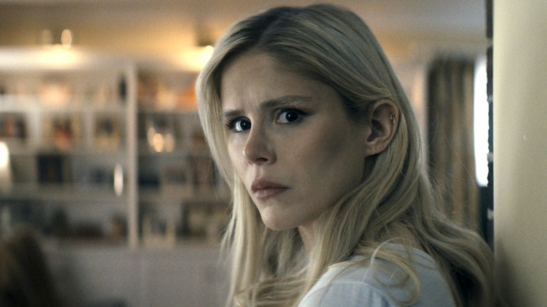 Erin Moriarty as Annie January/Starlight standing in a doorway with a look of concern in The Boys