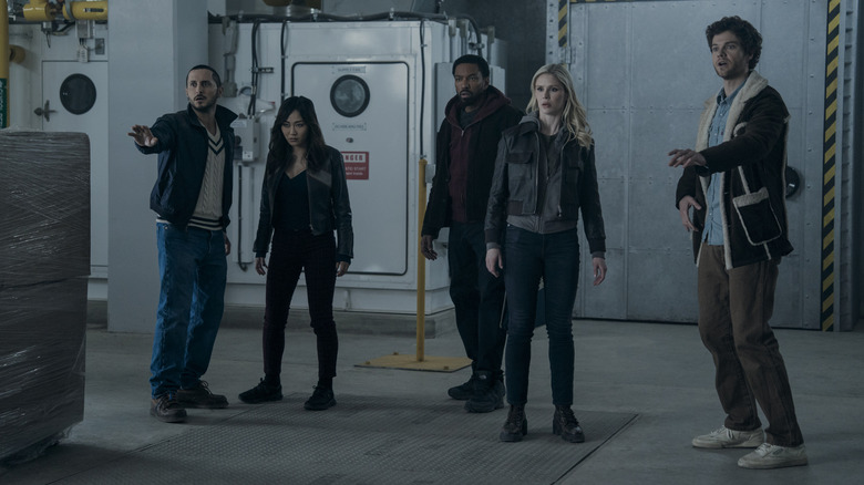 Tomer Capone as Frenchie holding his hand up and standing next to Karen Fukuhara as Kimiko, Laz Alonso as MM, Erin Moriarty as Annie January, and Jack Quaid as Hughie Campbell in The Boys