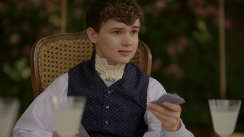 Gregory (Will Tilston) playing cards in Bridgerton