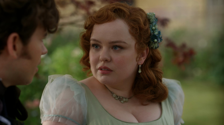 Penelope (Nicola Coughlan) staring at Colin (Luke Newton) in Bridgerton
