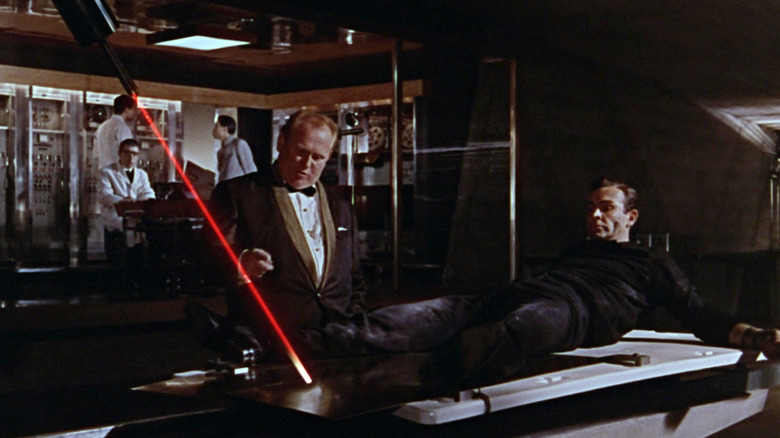 Gert Fröbe as Auric Goldfinger prepares to kill Sean Connery as James Bond with a laser in Goldfinger