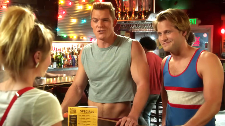 Brooklyn Nine-Nine, young Scully and Hitchcock at a restaurant called Wing Slutz. They're wearing very '80s outfits