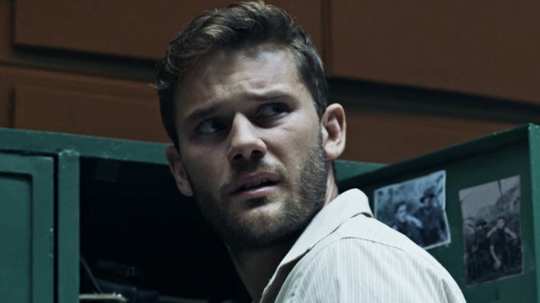 Jeremy Irvine's John Randolph Bentley looks across frame in Treadstone