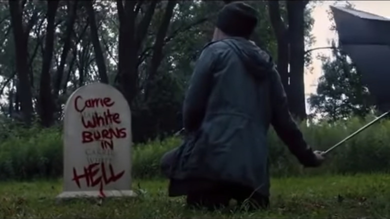 A remorseful Sue Snell (Gabriella Wilde) visits Carrie's vandalized grave