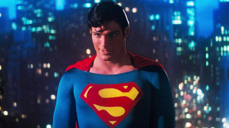 Christopher Reeve's Supermen stands against a city backdrop in Superman