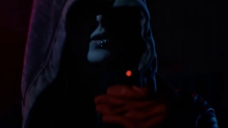 Ashley Greene, cloaked and holding a light