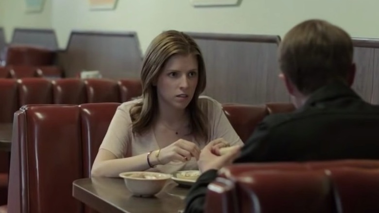 Anna Kendrick seated at diner