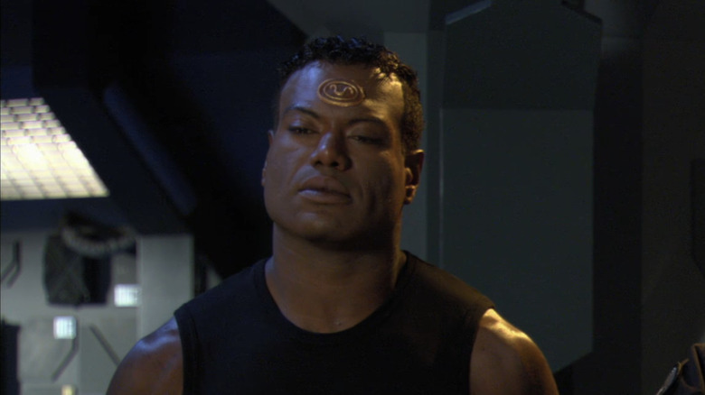 Christopher Judge's Teal'c stands at the SG-1 command center in Stargate SG-1
