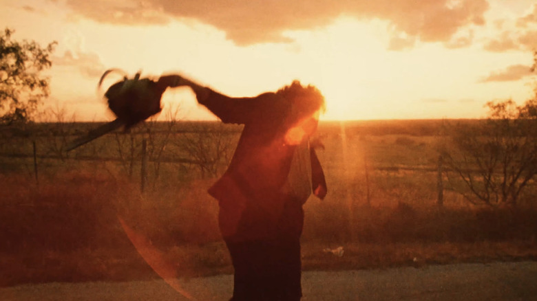 Gunnar Hansen's Leatherface dances in the sunset in The Texas Chainsaw Massacre