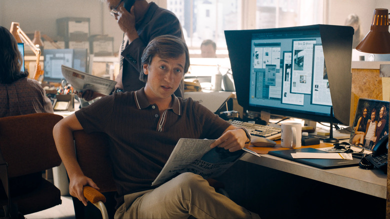 Jimmy Olsen at his desk reading a newspaper in 2025's Superman