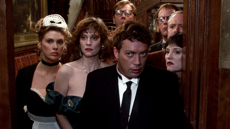 Wadsworth looks perplexed as he stands in front of the dinner guests looking out the front door in Clue