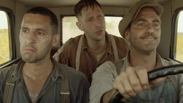 John Turturro as Pete, Tim Blake Nelson as Delmar, and George Clooney as Ulysses all riding in the car together in O Brother, Where Art Thou?