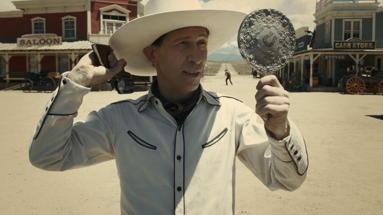 Tim Blake Nelson's Buster Scruggs looks in mirror in The Ballad of Buster Scruggs