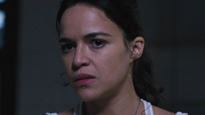 Letty in white tank top holding gun in Fast & Furious 6