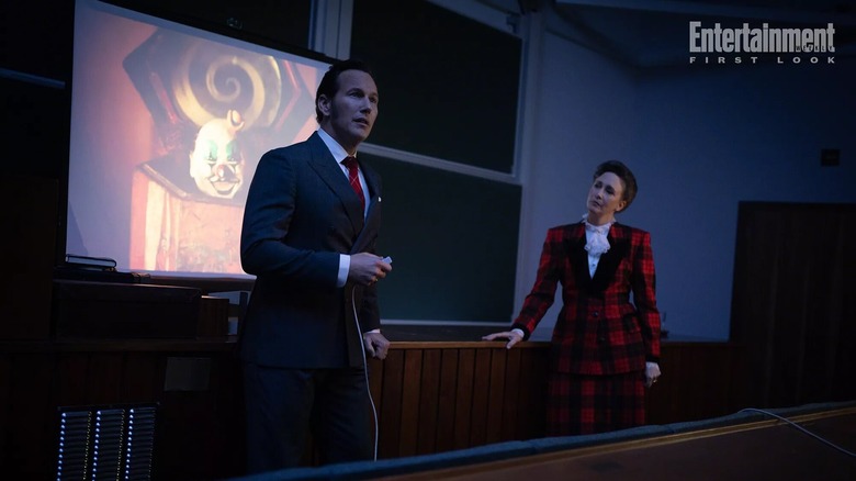 Vera Farmiga as Lorraine Warren and Patrick Wilson presenting a conference room in The Conjuring: Last Rites