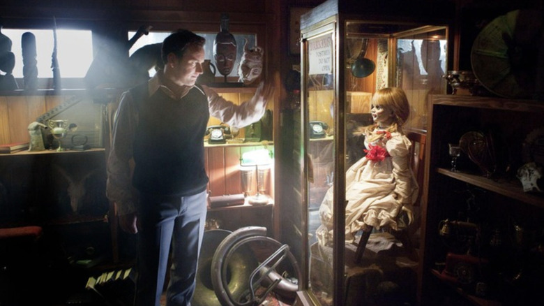 Ed Warren makes sure Annabelle is locked up in The Conjuring