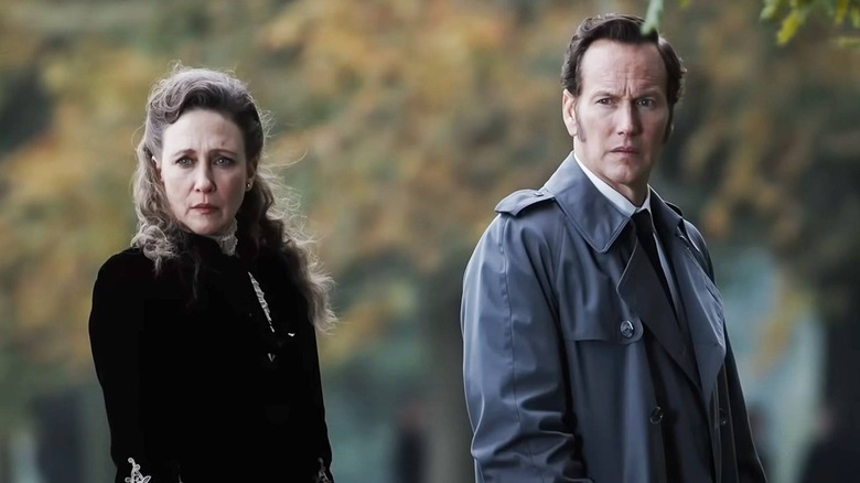 Lorraine and Ed Warren looking concerned in the autumn in The Conjuring: Last Rites