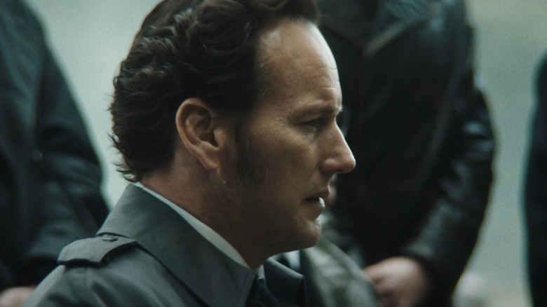 Patrick Wilson as Ed Warren sitting outside during a funeral in The Conjuring: Last Rites